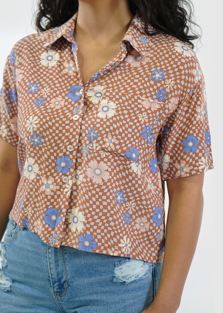 
                  
                    Close up of model wearing James cropped shirt in groovy summer print
                  
                