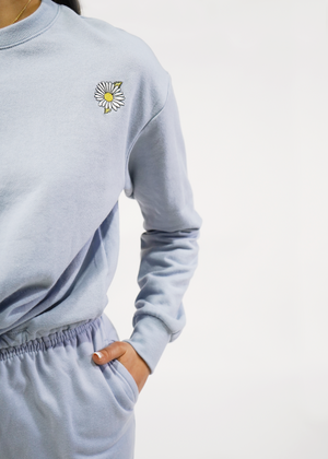 
                  
                    close up of aspen sweatshirt in zen blue with daisy embroidery on chest
                  
                