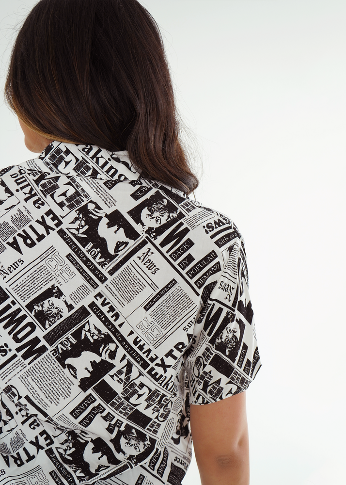 
                  
                    Back view of model wearing sydney shirt with newspaper print
                  
                