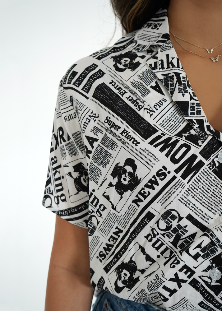 
                  
                    Close up front view of model wearing sydney shirt with newspaper print
                  
                