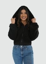 Front view of model wearing hoodie with hood on