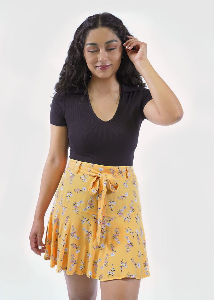 Front of model wearing Milly tiered skirt in Golden Bouquet