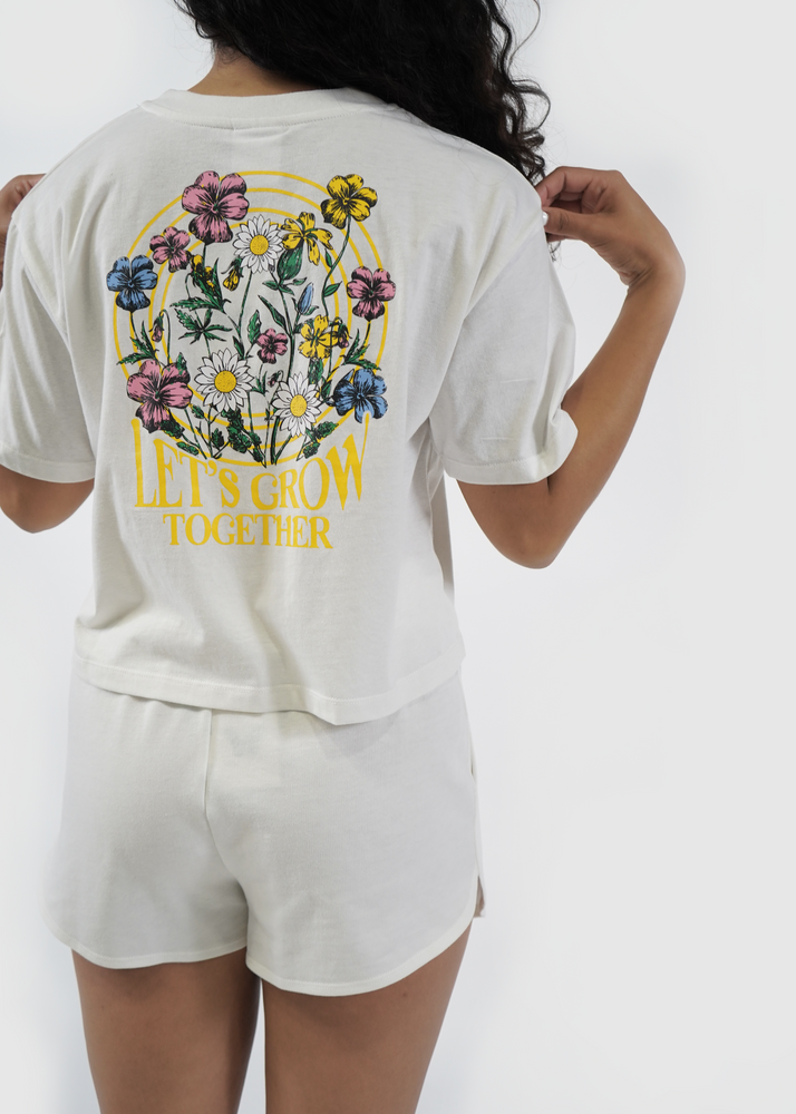 Back of model wearing Redondo crop tee in egret daisy print
