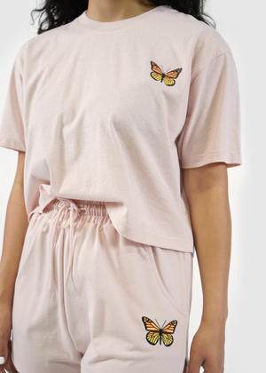 
                  
                    Close up of model wearing Redondo boxy crop tee in butterfly rose
                  
                