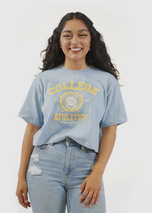 
                  
                    Front of model wearing Redondo Boxy Crop Tee in College Athletics screen print
                  
                