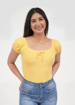 Front of model wearing Darling puff sleeve bodysuit in sunshine yellow