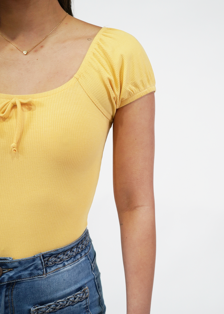 
                  
                    Close up of model wearing Darling puff sleeve bodysuit in sunshine yellow
                  
                