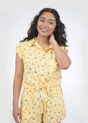 
                  
                    Front of model wearing Malibu doleman sleeve shirt in sunshine yellow daisy print
                  
                