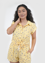 Front of model wearing Malibu doleman sleeve shirt in sunshine yellow daisy print