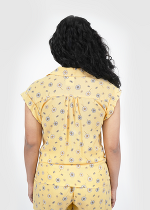 
                  
                    Back of model wearing Malibu doleman sleeve shirt in sunshine yellow daisy print
                  
                