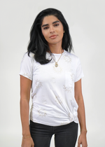 Front of model wearing knot tee with gold foil sun and moon print