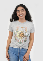 Front of model wearing Venice knot tee in nouveau sun and moon print