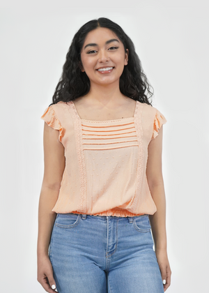 
                  
                    Front of model wearing Amy ruffle sleeve top in peach parfait
                  
                