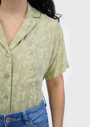 
                  
                    Close up of model wearing Sydney Shirt in Sage Green Mushroom print
                  
                